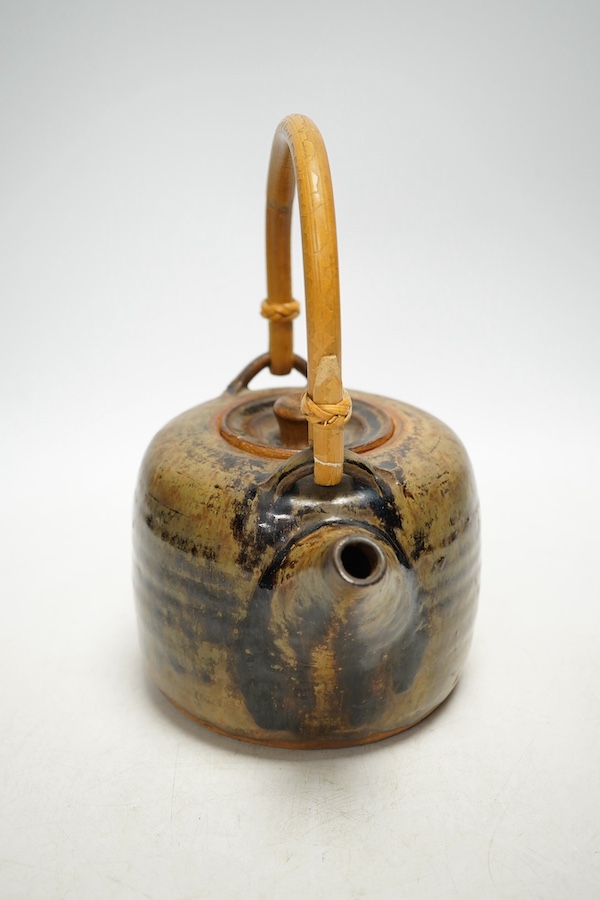 Pierre Culot (Belgian, 1938-2011), a studio pottery teapot with bamboo handle, stamped to the foot rim, 23cm high. Condition - fair to good, minor chipping